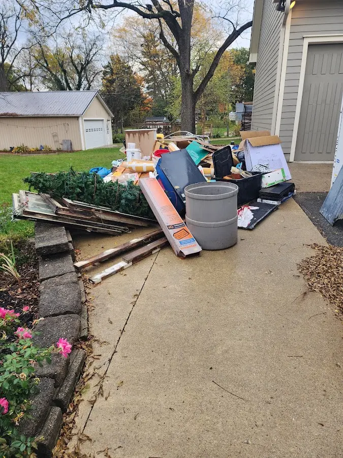 Dumpster being loaded with debris for Roofing Dumpster Rental in Coeur d'Alene